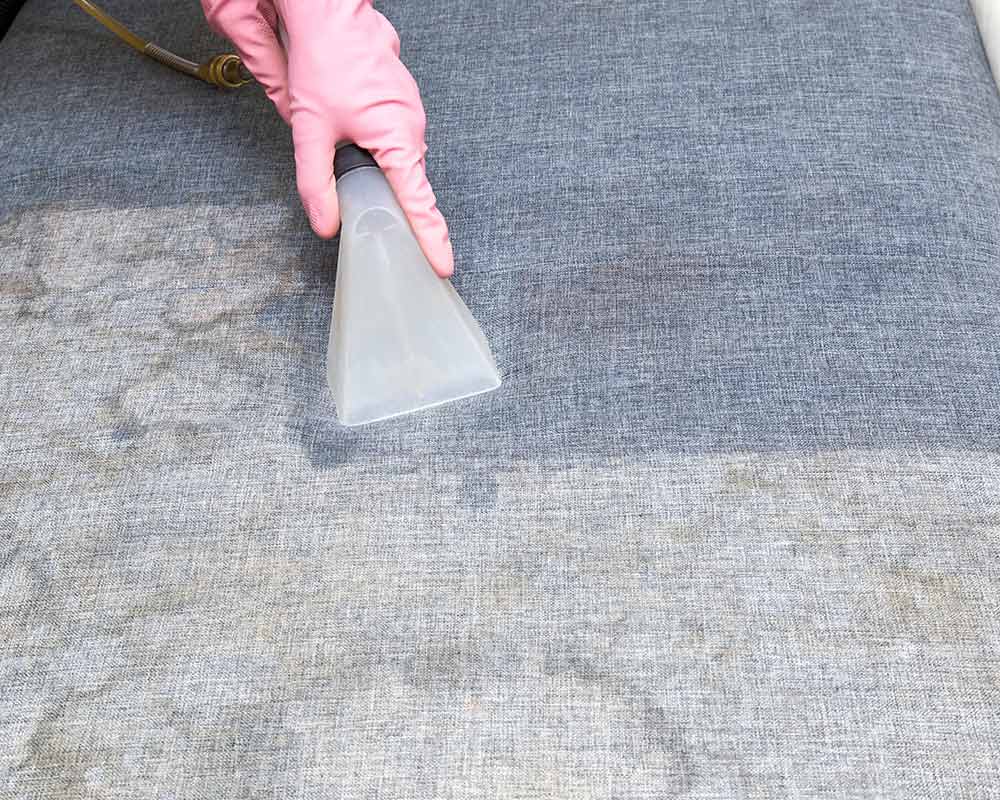 person cleaning furniture with vacuum kountze tx